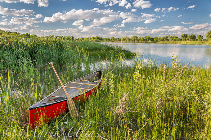 red canoe on lake shore